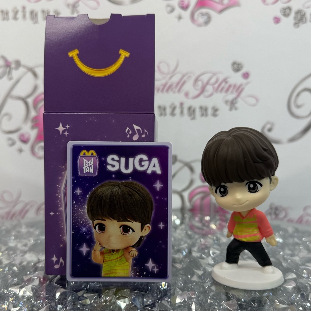 McDonald's SUGA Toy Figure with Purple and Yellow Highlights tiny tan toy